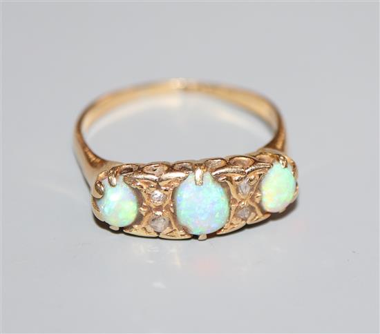 An early 20th century, 18ct gold, three stone white opal and diamond chip set ring, size R.